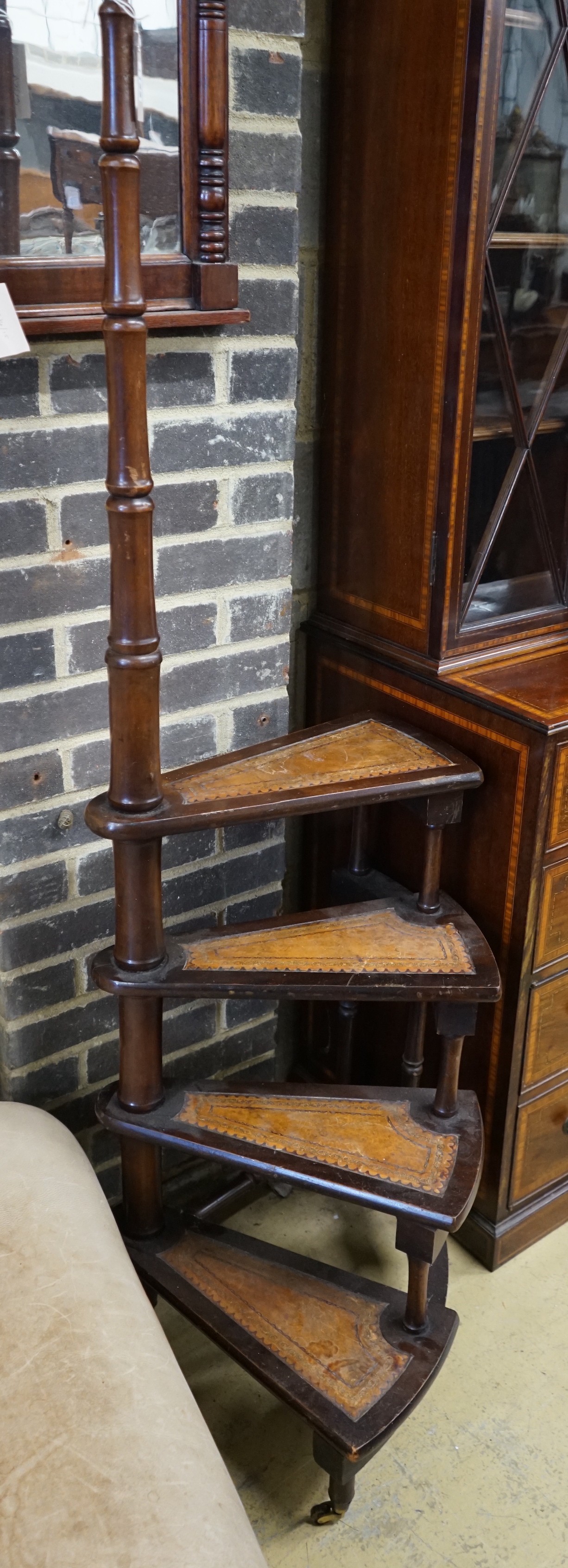 A set of reproduction Victorian style mahogany four tread library steps on brass castors, height 170cm